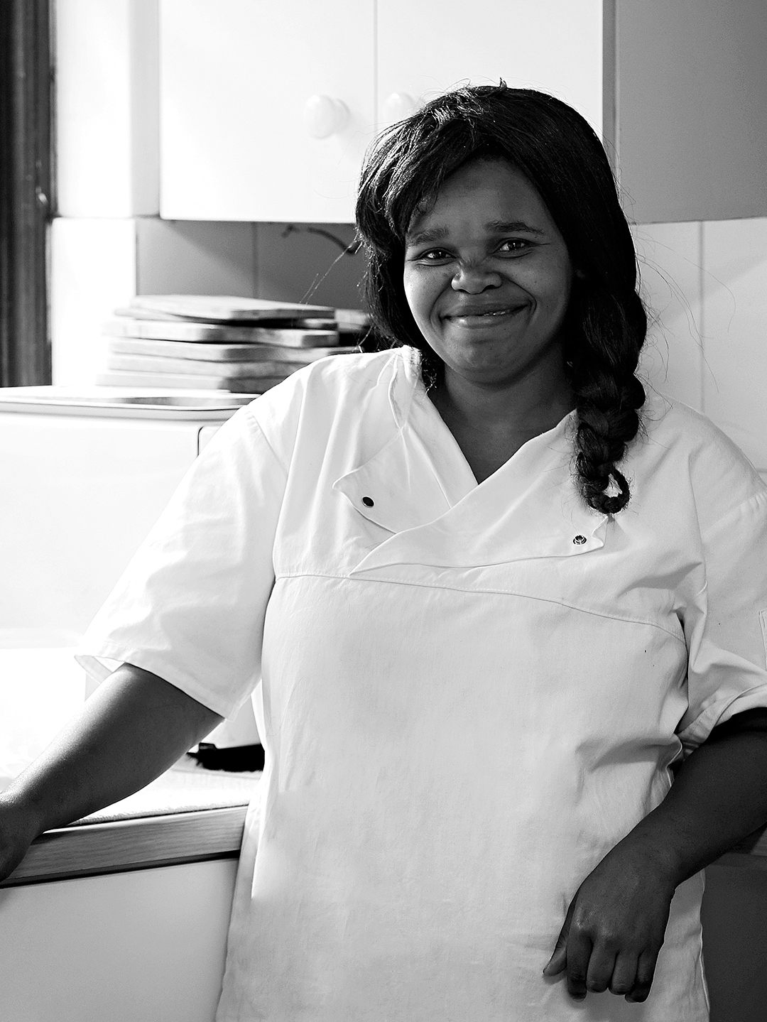 A smiling Elephant House staff member in the kitchen.