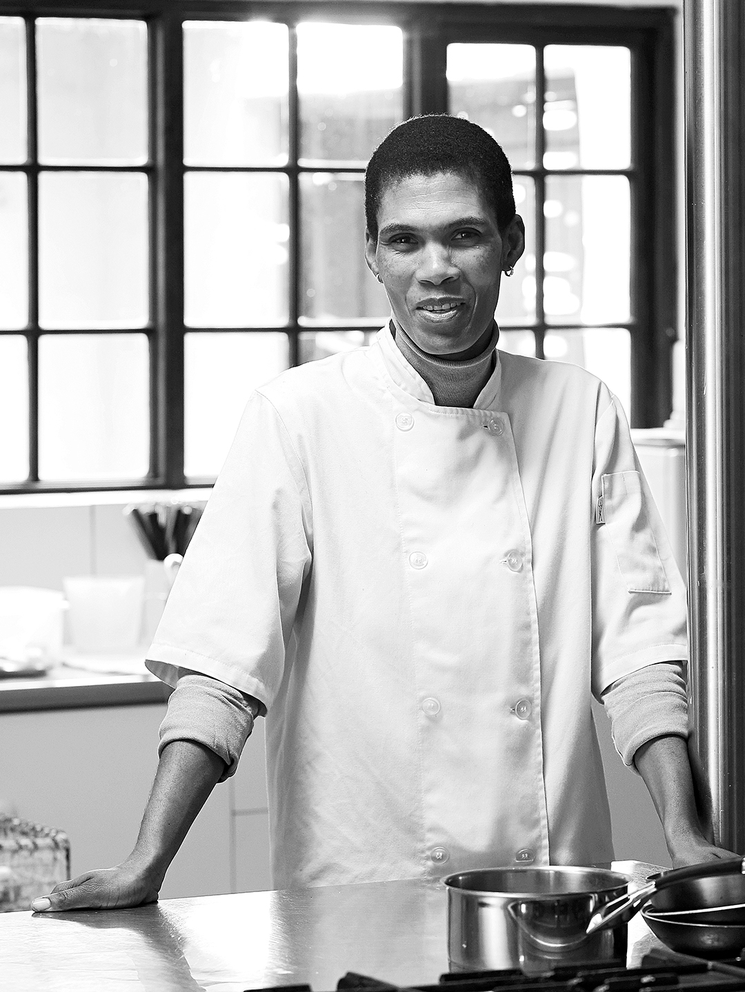 A smiling Elephant House staff member in the kitchen.